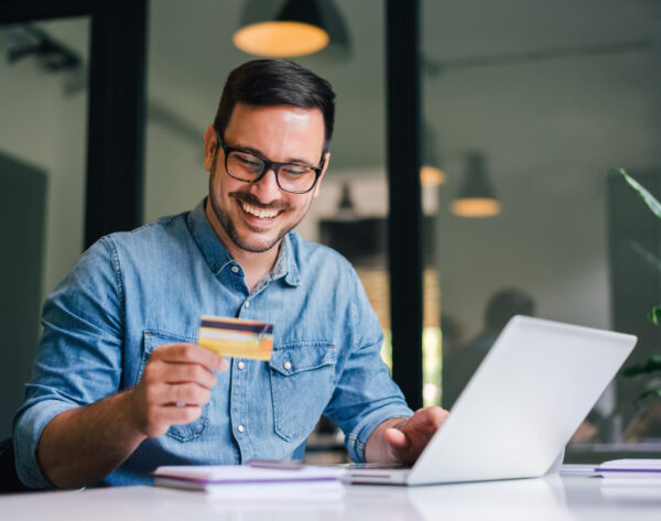 happy-cheerful-smiling-young-adult-man-doing-online-shopping-collecting-fee